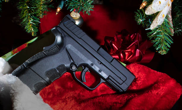 istock New handgun under the Christmas tree 1194657000