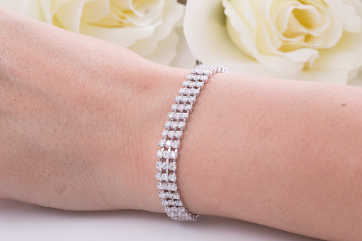 Beautiful Silver Bracelete with diamonds on white background.