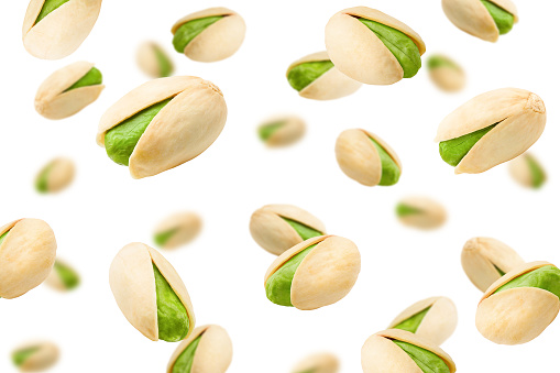 Falling pistachio isolated on white background, selective focus