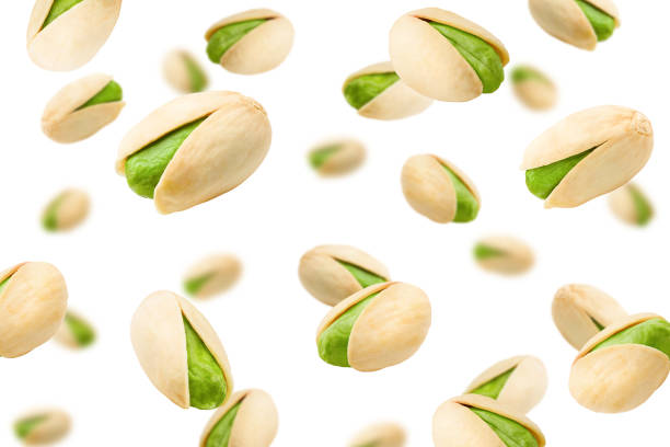 Falling pistachio isolated on white background, selective focus Falling pistachio isolated on white background, selective focus Pistachio stock pictures, royalty-free photos & images