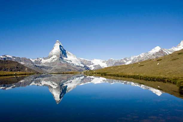 Switzerland travel - Female hiking around the Riffelsee in Zermatt, with fantasic view of the Matterhorn
