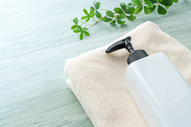 istock Liquid soap bottle and towel on wooden background 1194663106