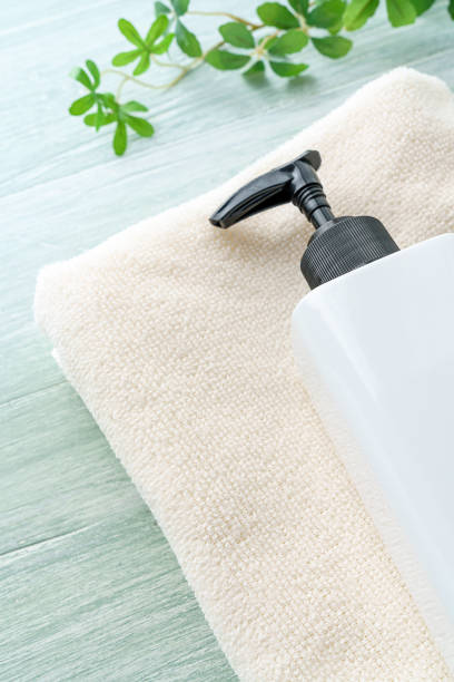 istock Liquid soap bottle and towel on wooden background 1194663117