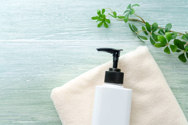 istock Liquid soap bottle and towel on wooden background 1194663128