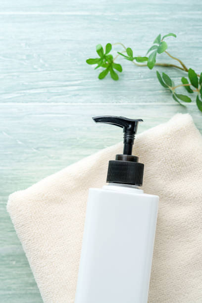 istock Liquid soap bottle and towel on wooden background 1194663132