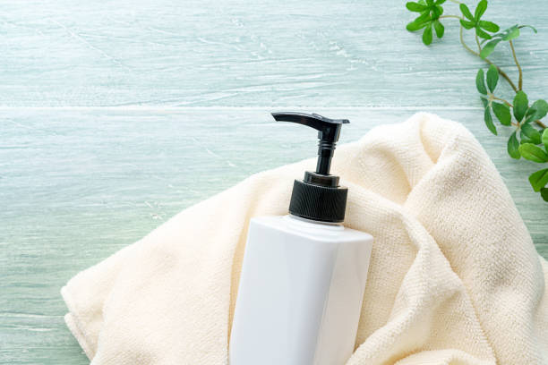 istock Liquid soap bottle and towel on wooden background 1194663207