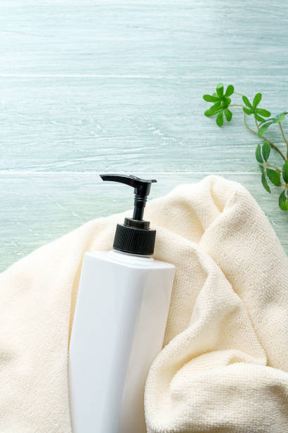 istock Liquid soap bottle and towel on wooden background 1194663217