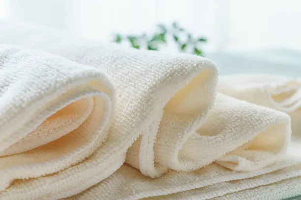 Stack of clean towels on wooden background