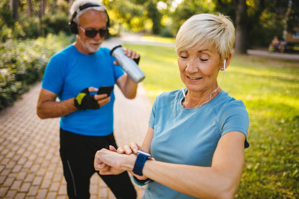 istock Senior woman using smart watch while exercising outdoors 1194665725