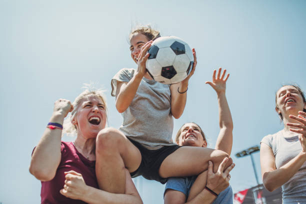 Female soccer players celebrating together Group of women, female soccer players together outdoors, celebrating victory. football player girlfriend stock pictures, royalty-free photos & images