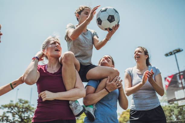 Women soccer players celebrating together Group of women, female soccer players together outdoors, celebrating victory. football player girlfriend stock pictures, royalty-free photos & images