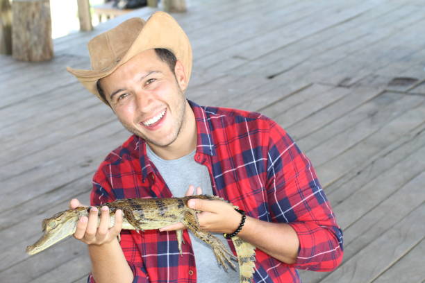 istock Indigenous man holding a caiman 1194666727