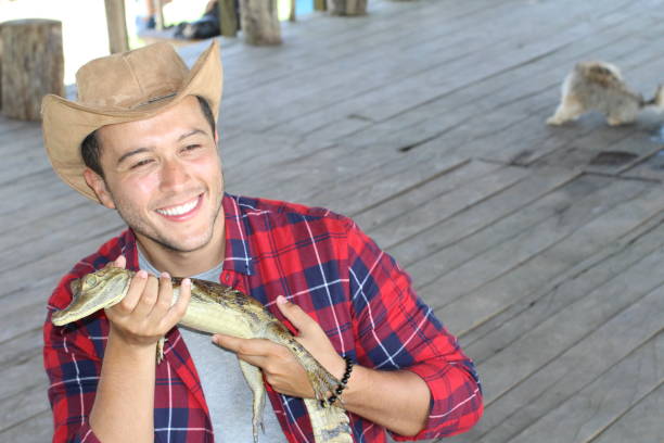istock Zookeeper enjoying work with a baby caiman 1194666732