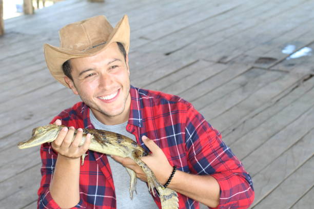 istock Indigenous man holding a caiman 1194666737