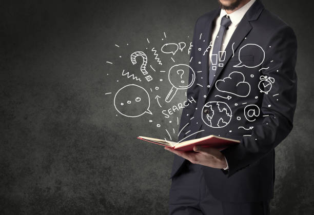 istock Businessman holding a book. 1194666997