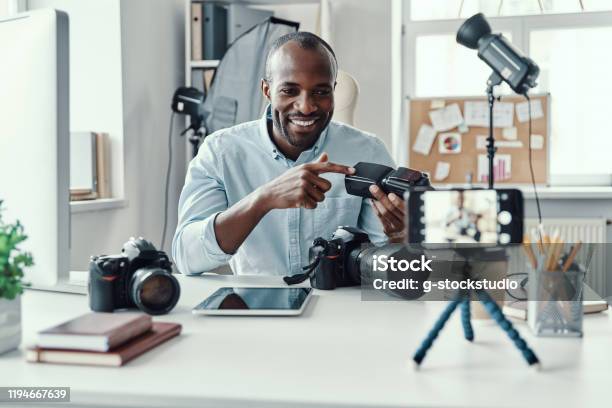 Charming Young African Man In Shirt Stock Photo - Download Image Now - Filming, Men, Office