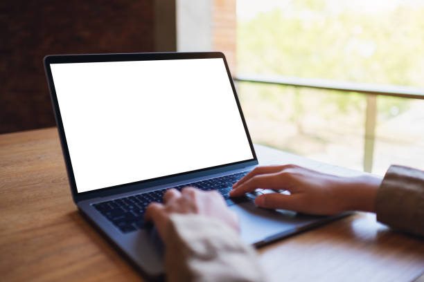 istock a woman using and typing on laptop computer with blank white desktop screen 1194668044