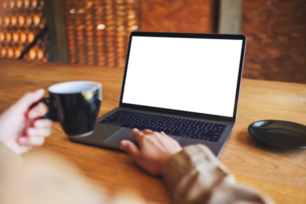 istock a woman using and touching on laptop touchpad with blank white desktop screen while drinking coffee 1194668059
