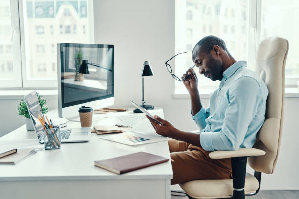 istock Concentrated young African man in shirt 1194668067