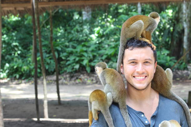istock Man and Titi monkeys in the Amazon region 1194668095