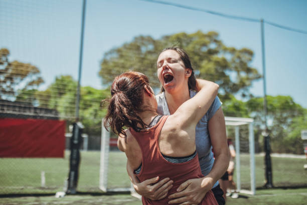 istock Two female soccer players hugging 1194669187