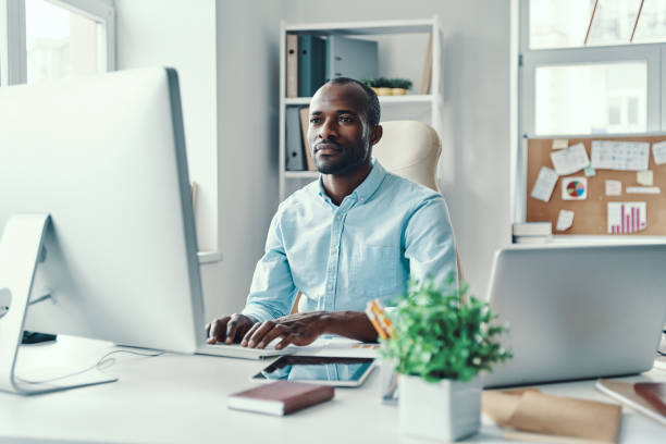 istock Concentrated young African man in shirt 1194669311
