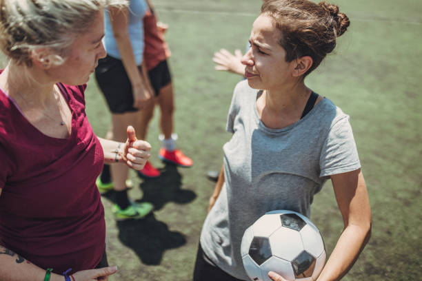 Female soccer players on soccer field Group of women, female soccer players together outdoors on soccer field. football player girlfriend stock pictures, royalty-free photos & images