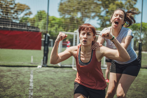 Female soccer players celebrating a goal Two women, female soccer players together outdoors, celebrating victory. football player girlfriend stock pictures, royalty-free photos & images