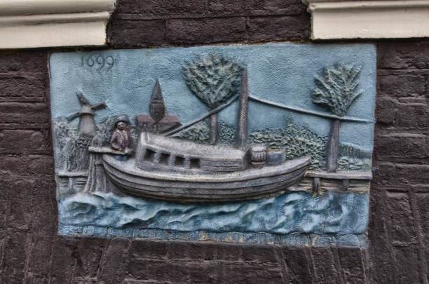 Amsterdam, Holland, August 2019. Artistic detail on the facade of a house in the center: date 1699 visible.