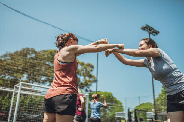 Female soccer players celebrating a goal together Group of women, female soccer players together outdoors, celebrating victory. football player girlfriend stock pictures, royalty-free photos & images