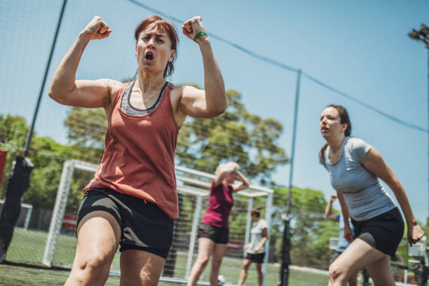 Women soccer players celebrating a goal together Group of women, female soccer players together outdoors, celebrating victory. football player girlfriend stock pictures, royalty-free photos & images