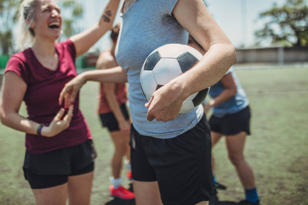 Female soccer players on soccer field Group of women, female soccer players together outdoors on soccer field. football player girlfriend stock pictures, royalty-free photos & images