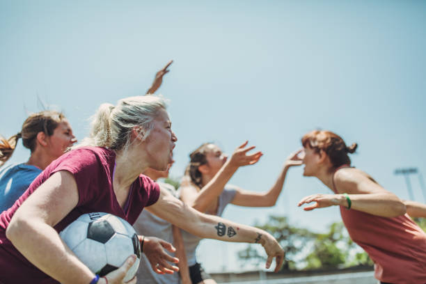 Female soccer players arguing outdoors on soccer field Group of women, female soccer players arguing outdoors on soccer field. football player girlfriend stock pictures, royalty-free photos & images