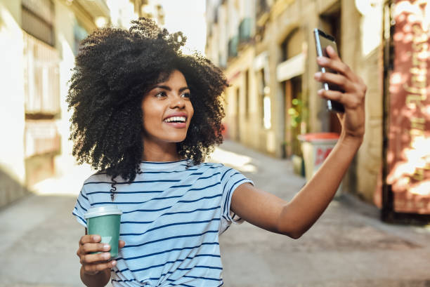 istock Girl drinking coffee to go and taking a selfie 1194671059