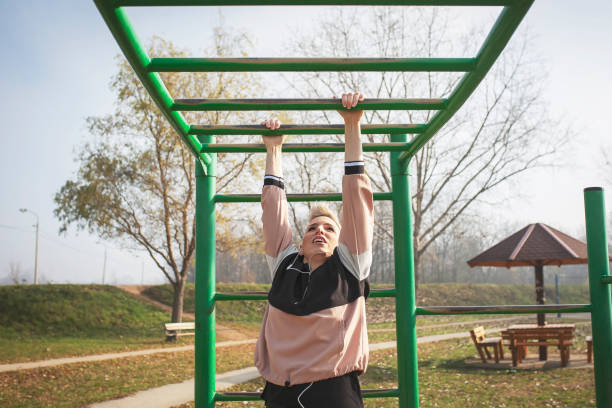 istock Sporty woman exercising  in park 1194671114