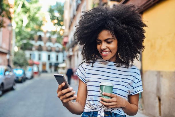 istock Girl using phone and having a coffee while waiting transportation 1194671574