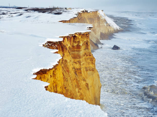 istock Sandy winter snowy cliff above the storm sea 1194671733