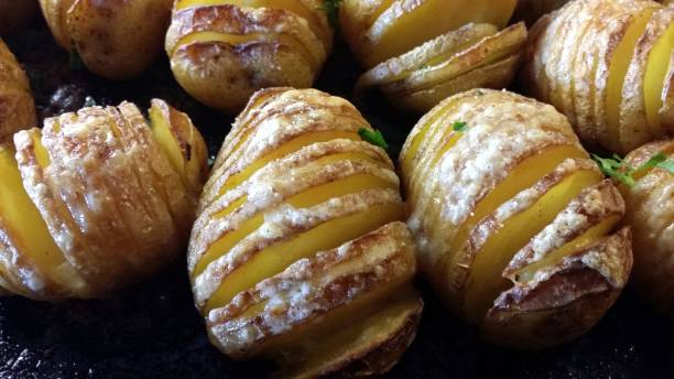 istock Sliced baked buttered potatoes ready to be served 1194672624