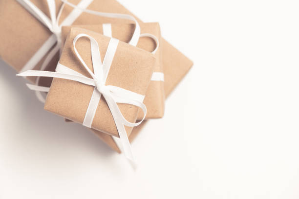 istock Brown gift box tied with white ribbon on clear background, copy space, eco-friendly present concept 1194673013