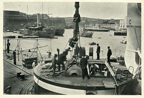 Vintage photograph of Hoisting big gun inside turret, HMS Trafalgar, battleship, 19th Century.  Malta dockyard