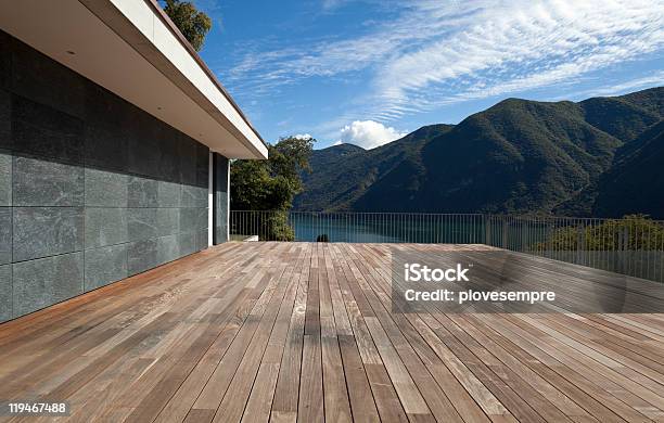 A Wooden Roomy Patio Overlooking The Mountains And The Water Stock Photo - Download Image Now