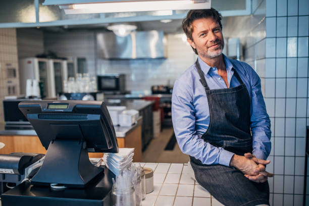 istock Mature man working  in the coffee shop 1194675136