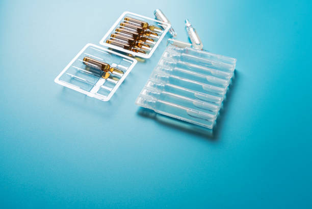 istock Ampoules with medicine on a blue background 1194675435