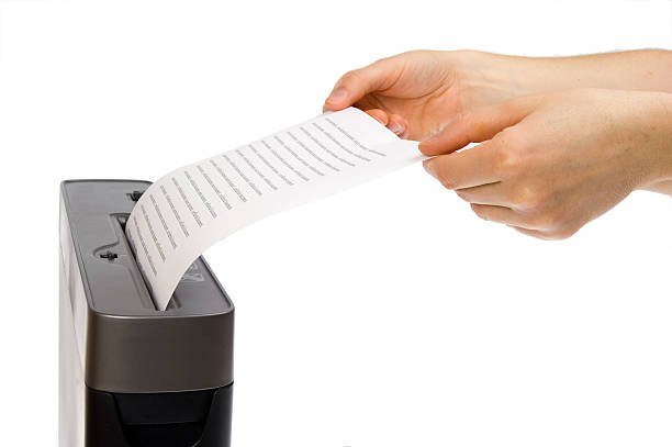 istock hand and paper shredder 119467568