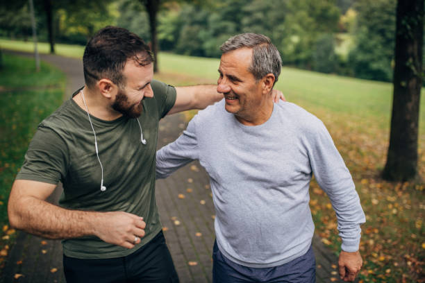 istock Father and son jogging in park 1194676901