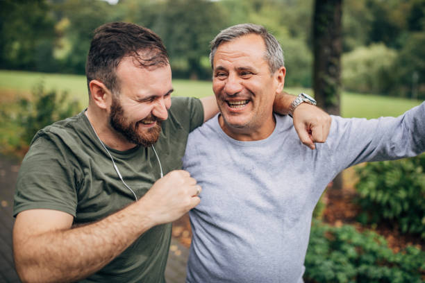 istock Father and son jogging in park 1194676937