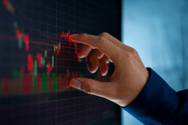 istock Businessman touch candlestick chart from stock market 1194677181