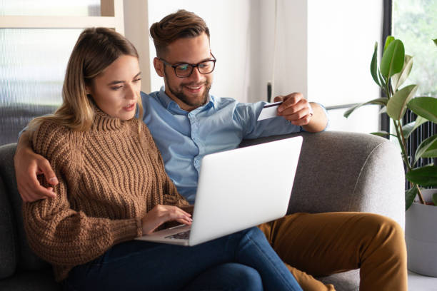 istock Young couple ordering online, looking in laptop 1194677877