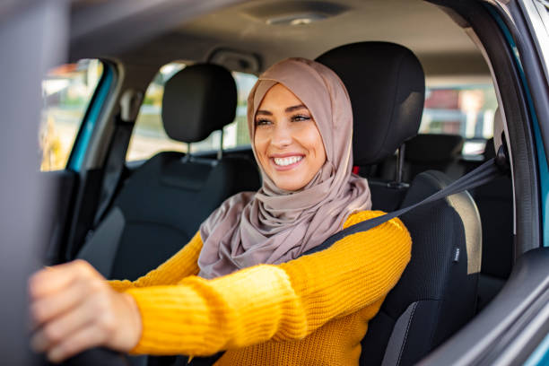 Arab women driving car. Portrait of muslim young woman driving her car. Arab women driving car. Middle Eastern Woman Driving a Car, Looking Forward. Get driving license concept pakistan photos stock pictures, royalty-free photos & images