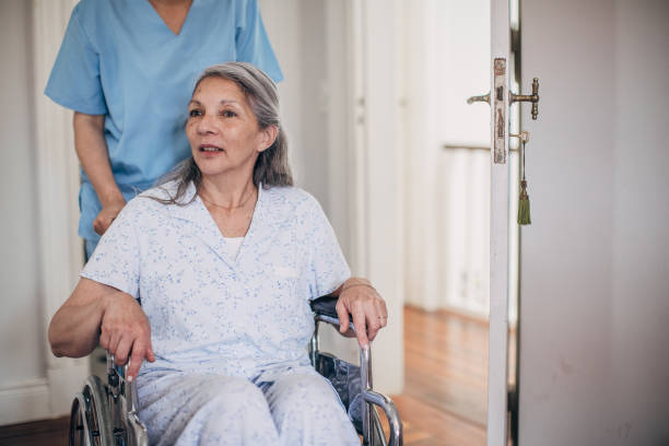 istock Nurse helping senior paraplegic woman 1194678438